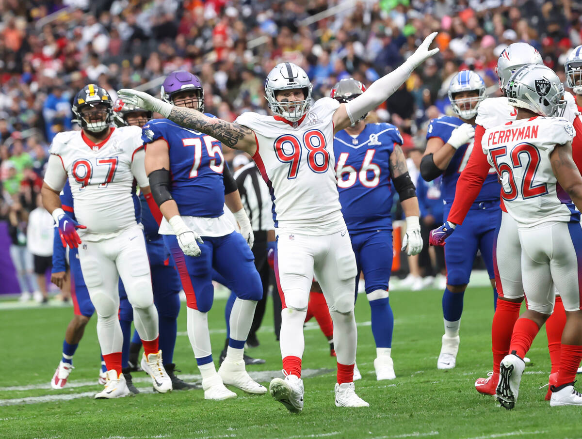 AFC defensive end Maxx Crosby of the Las Vegas Raiders (98) celebrates after blocking a pass fr ...