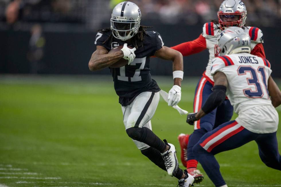 Raiders wide receiver Davante Adams (17) runs after a catch with New England Patriots linebacke ...