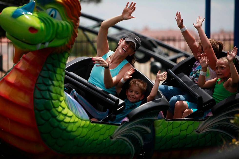 Desiree Cope rides in the front row of the Dragon Coast with son Jaxon Cope, 4, at Las Vegas Mi ...