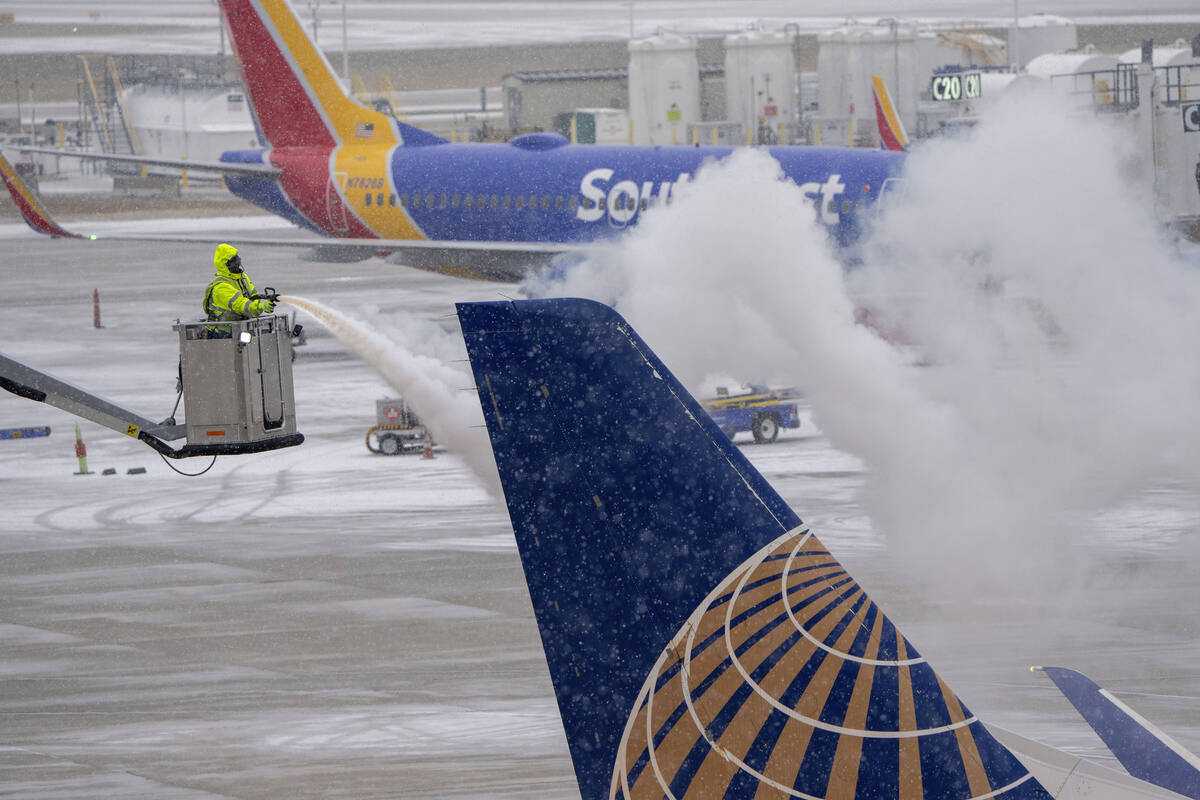 A United Express plane is de-iced Thursday, Dec. 22, 2022 at Mitchell Airport in Milwaukee. A ...