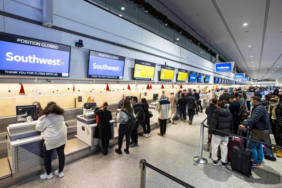 Passengers check-in at Southwest Airlines at Harry Reid International Airport on Thursday, Dec. ...