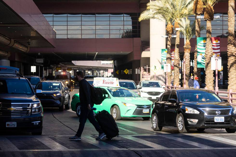 Passengers are dropped off at Harry Reid International Airport on Thursday, Dec. 22, 2022, in L ...