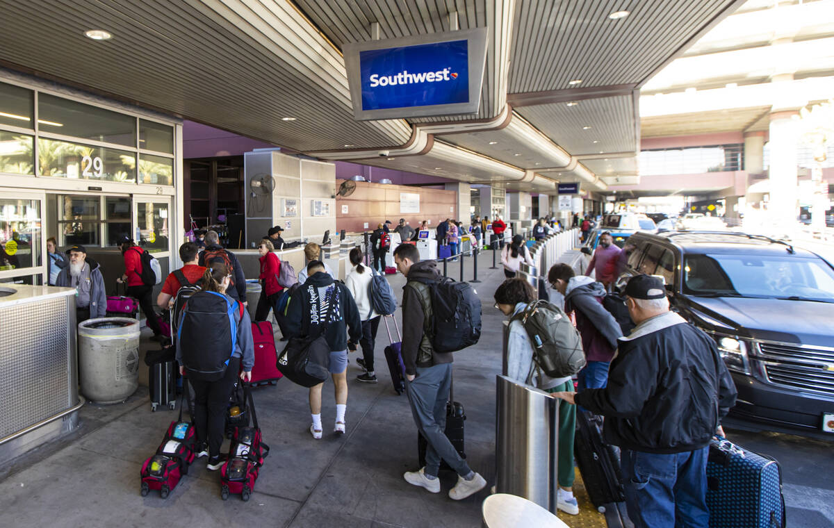 Passengers arrive to check-in at Southwest Airlines at Harry Reid International Airport on Thur ...