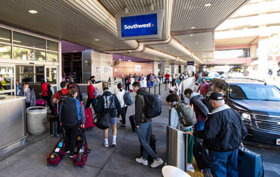 Passengers arrive to check-in at Southwest Airlines at Harry Reid International Airport on Thur ...
