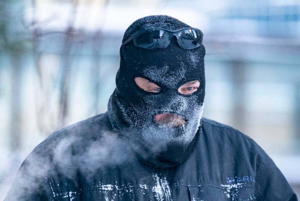 Charles Zajicek uses a power sweeper to clear snow off the sidewalk Thursday, Dec. 22, 2022 in ...