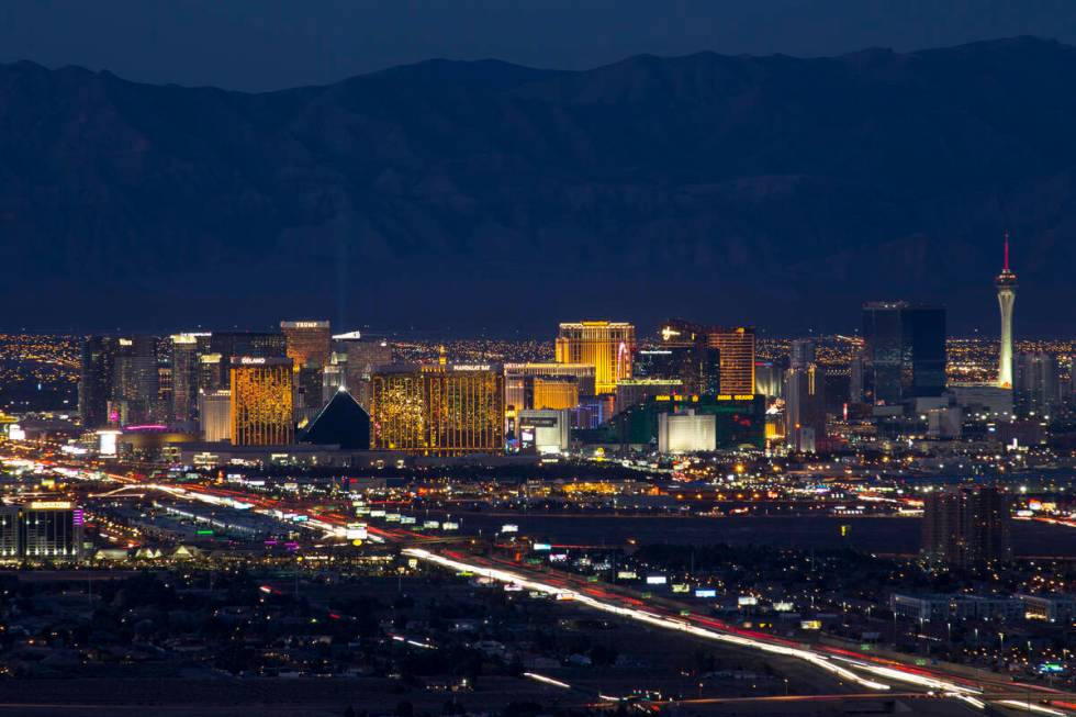 Traffic moves along Interstate 15 as Las Vegas casinos illuminate the skyline at dusk on Tuesda ...