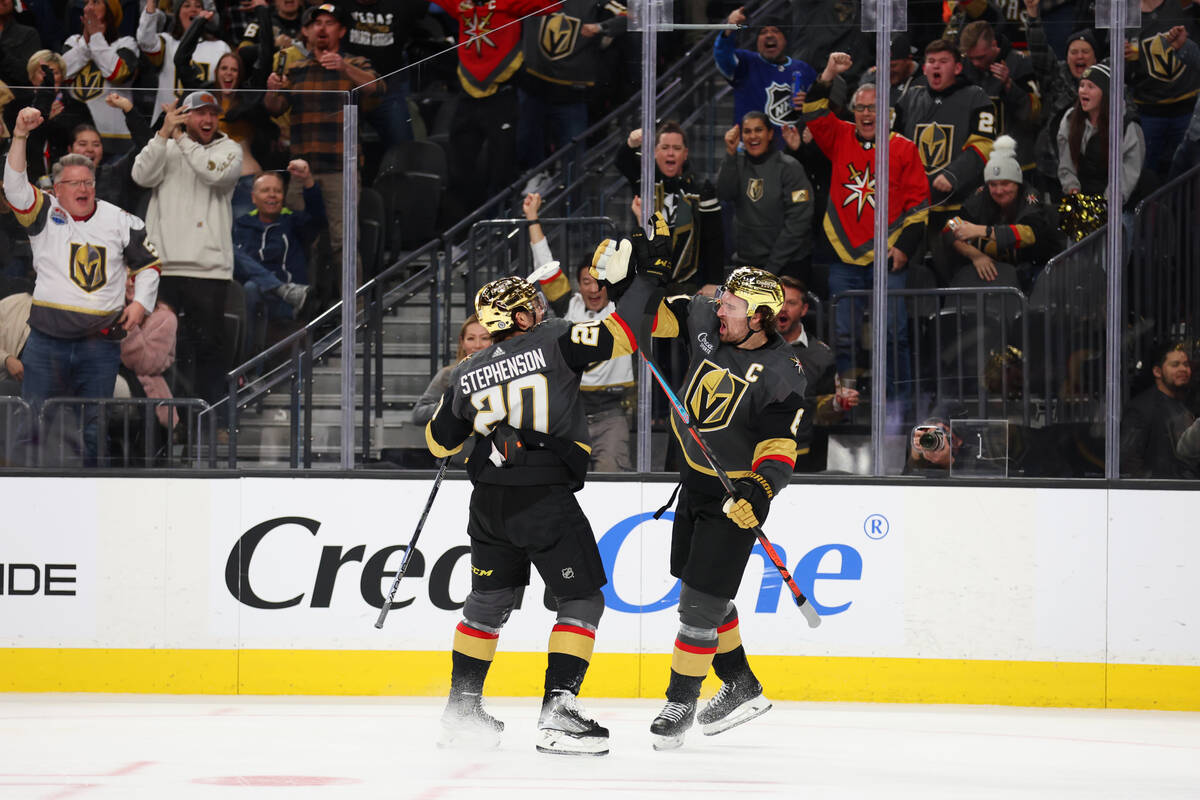 Vegas Golden Knights right wing Mark Stone (61) celebrates a goal with center Chandler Stephens ...