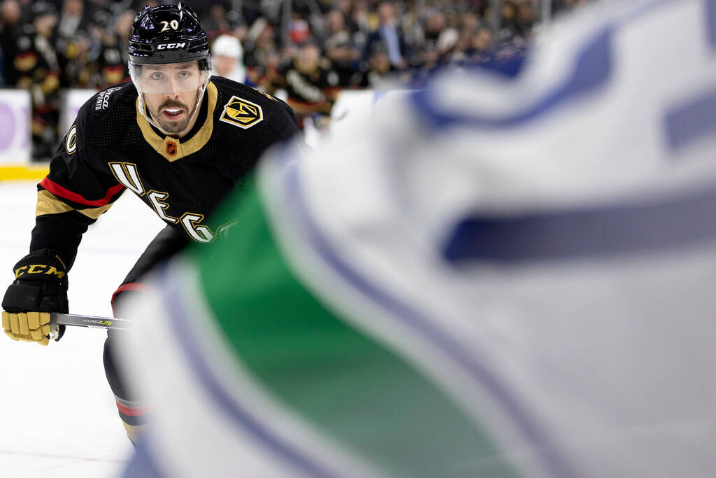 Golden Knights center Chandler Stephenson (20) skates for the puck against Canucks defenseman T ...