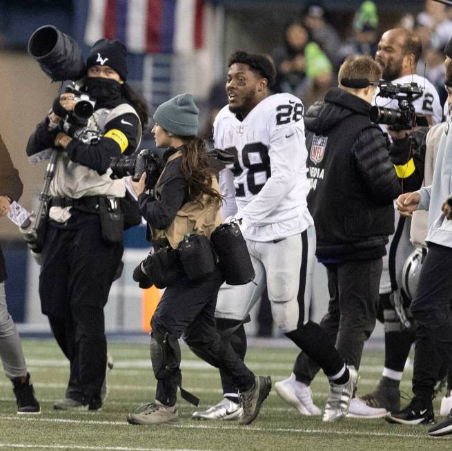 Raiders running back Josh Jacobs (28) smiles on the field after the team’s 40-34 overtim ...