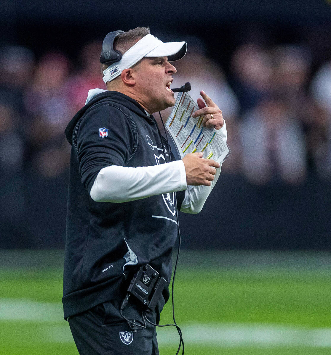 Raiders Head Coach Josh McDaniels yells to his players on the field versus the New England Patr ...