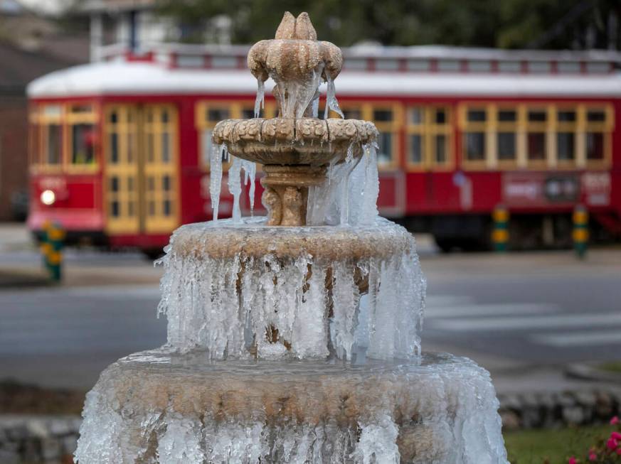 The fountain is frozen as temperatures hovered in the mid 20's at Jacob Schoen & Son Funeral Ho ...