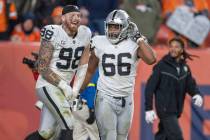 Raiders defensive end Maxx Crosby (98) runs on the field with offensive lineman Dylan Parham (6 ...
