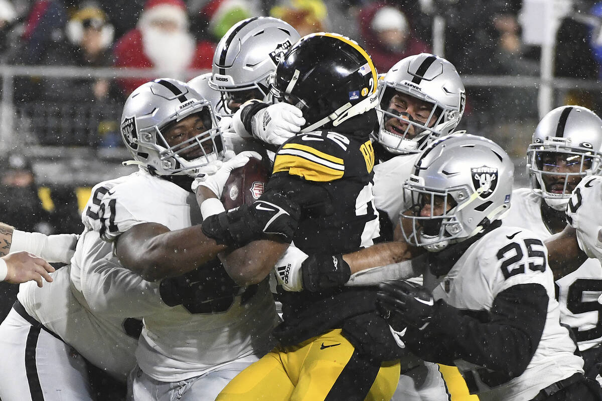 Pittsburgh Steelers running back Najee Harris (22) is gang tackled during the first half of an ...