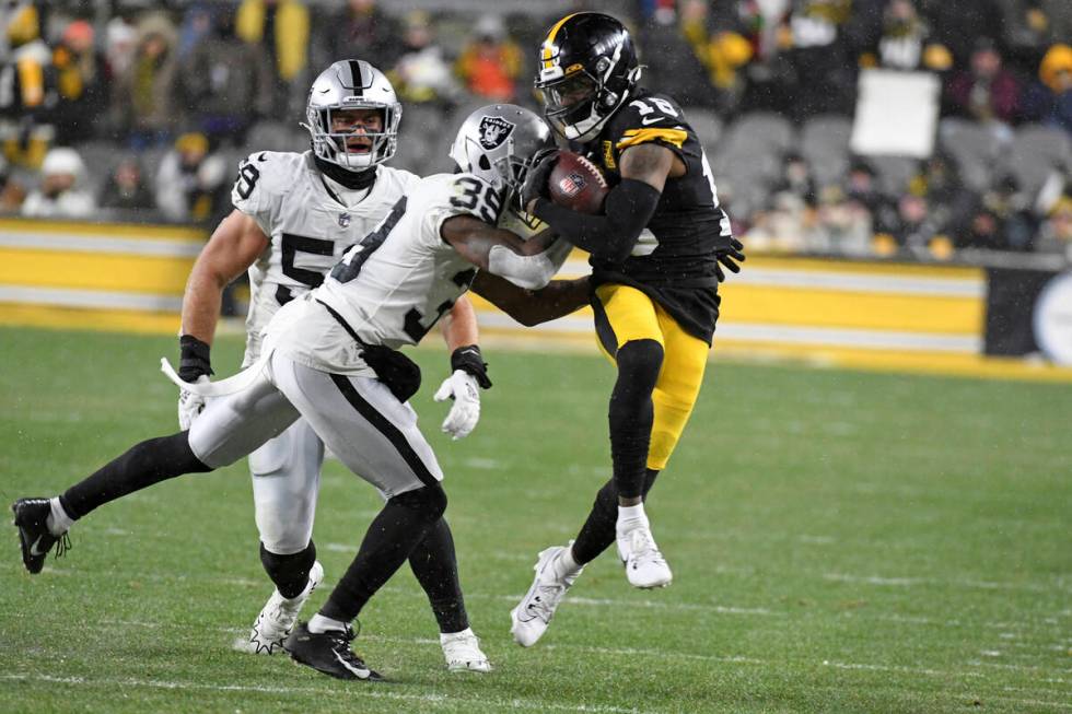 Pittsburgh Steelers wide receiver Diontae Johnson (18) is tackled by Las Vegas Raiders running ...