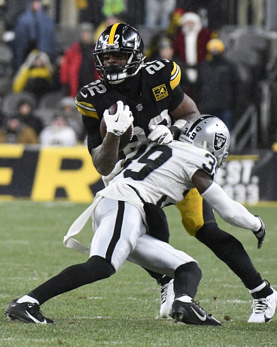 Pittsburgh Steelers running back Najee Harris (22) is tackled by Las Vegas Raiders cornerback N ...