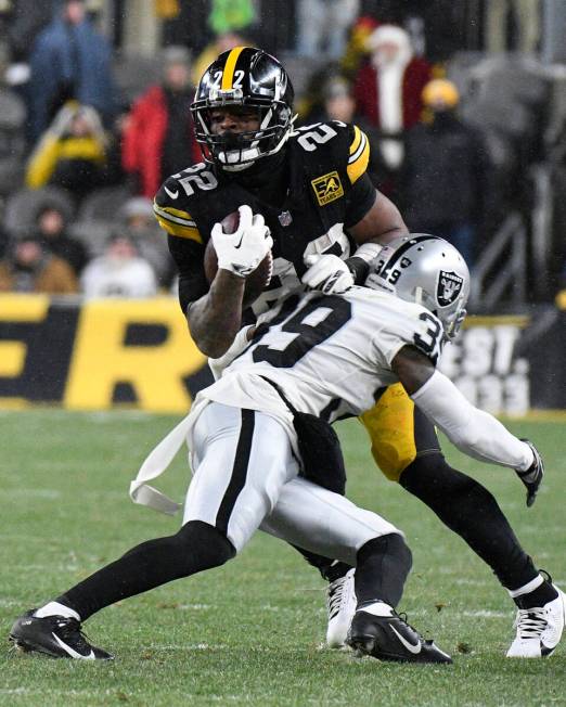 Pittsburgh Steelers running back Najee Harris (22) is tackled by Las Vegas Raiders cornerback N ...