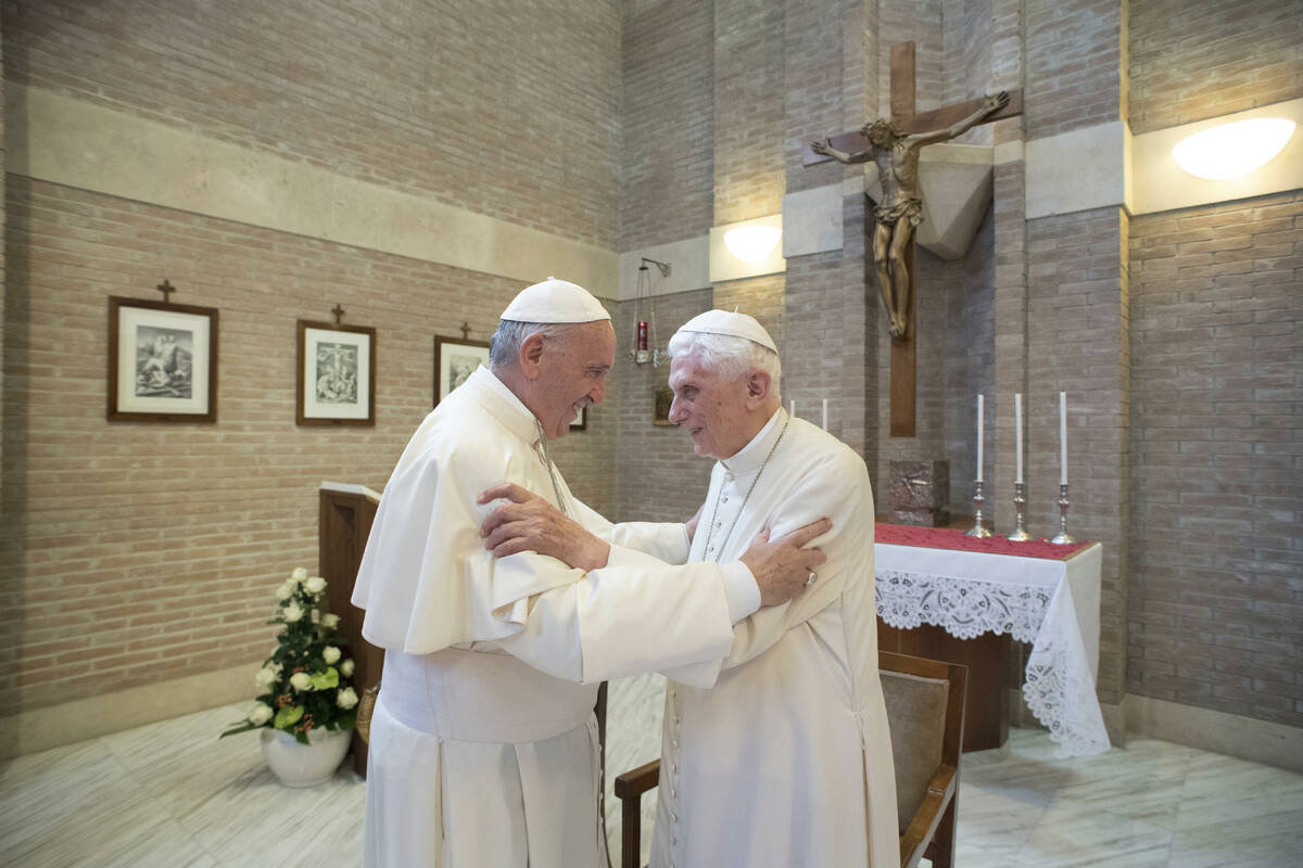 FILE - Pope Francis, left, embraces Emeritus Pope Benedict XVI, at the Vatican, June 28, 2017. ...