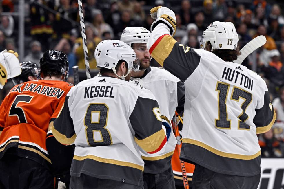 Vegas Golden Knights defenseman Ben Hutton, right, celebrates his goal against the Anaheim Duck ...