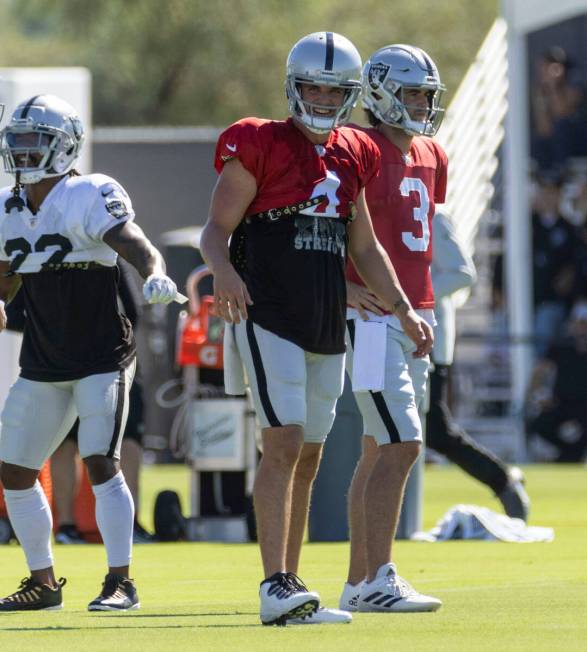 Raiders quarterback Derek Carr (4) and quarterback Jarrett Stidham (3) line up for drills durin ...