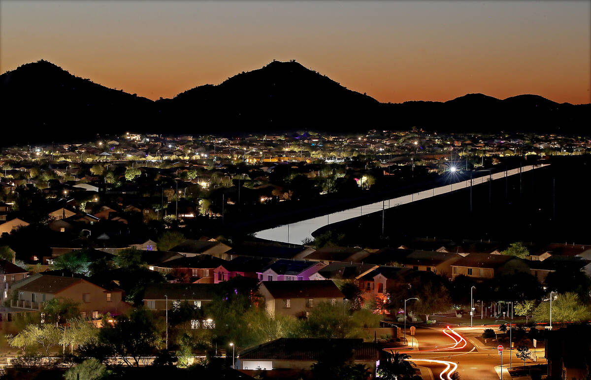 The Central Arizona Project Canal runs beside a community in the suburbs of North Phoenix, Oct. ...