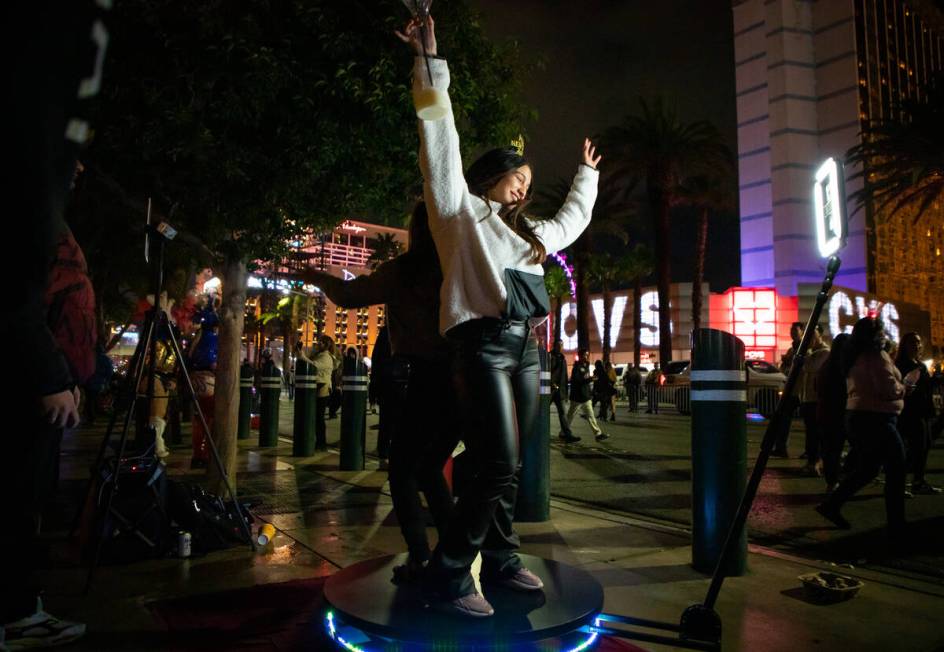 Erandy Soto, back left, and Grecia Rodriguez, front right, film a video on a 360 swivel camera ...