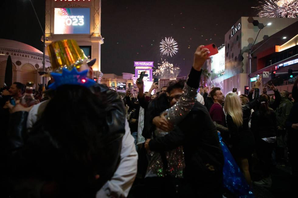 New Year’s revelers watch the fireworks on the Strip on Sunday, Jan. 1, 2023, in Las Vegas. ( ...