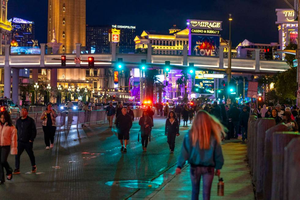 New Year’s Eve revelers move along the Strip on Saturday, Dec. 31, 2022, in Las Vegas. ( ...