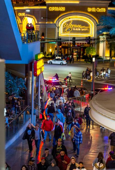 New Year’s Eve revelers make their way along the Strip near the Fashion Show mall on Saturday ...