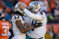 Raiders quarterback Derek Carr (4) congratulates wide receiver Davante Adams (17) after throwin ...