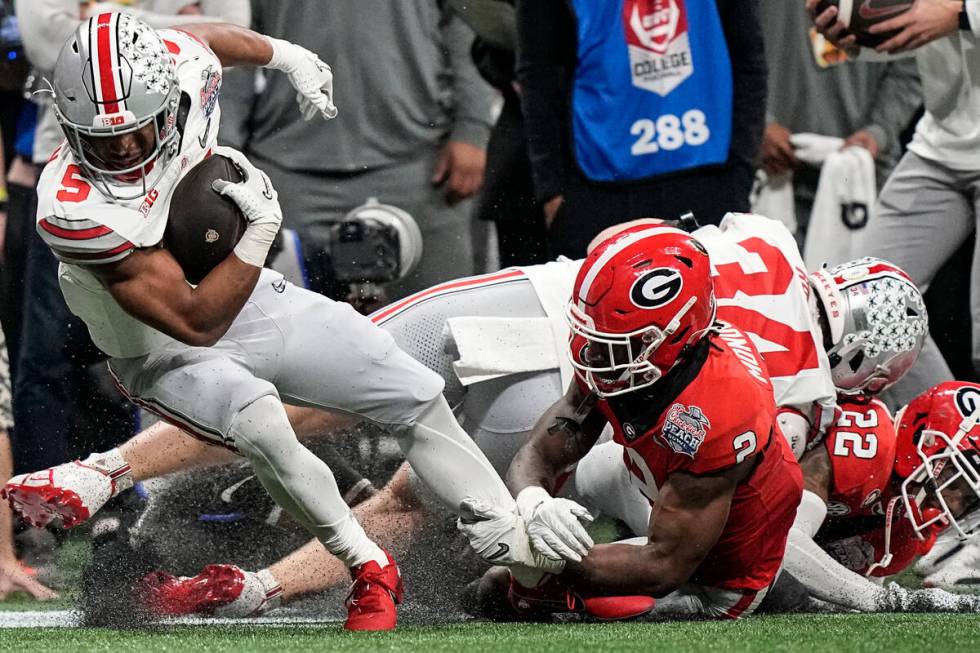 Ohio State running back Dallan Hayden (5) runs against Georgia linebacker Smael Mondon Jr. (2) ...