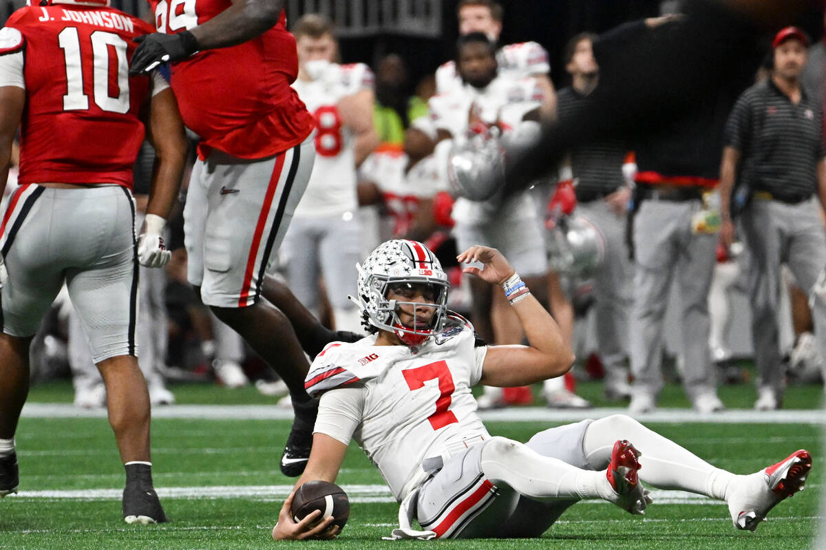 Ohio State quarterback C.J. Stroud (7) sits on the turf after being sacked by Georgia during th ...