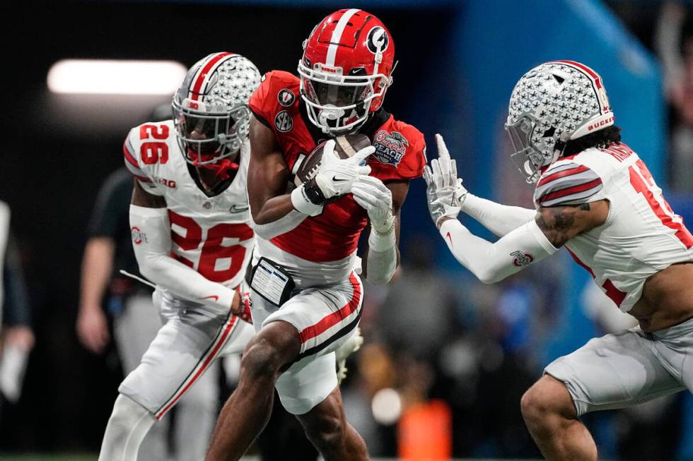 Georgia wide receiver Adonai Mitchell (5) makes the catch against Ohio State cornerback Cameron ...