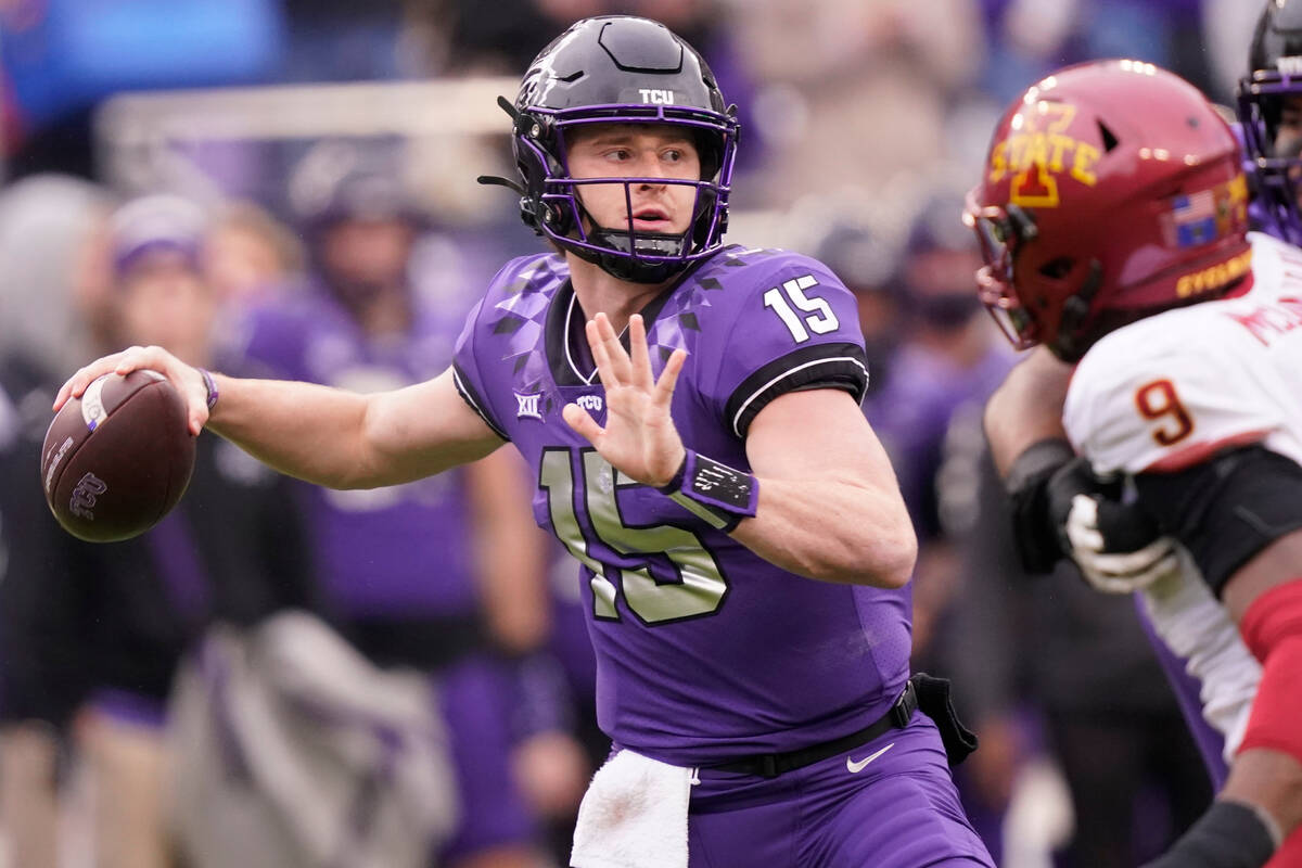 FILE - TCU quarterback Max Duggan (15) passes with blocking from teammate offensive tackle Andr ...