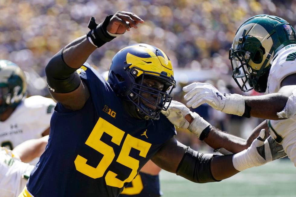 FILE - Michigan award-winning center Olusegun Oluwatimi plays during the second half of an NCAA ...