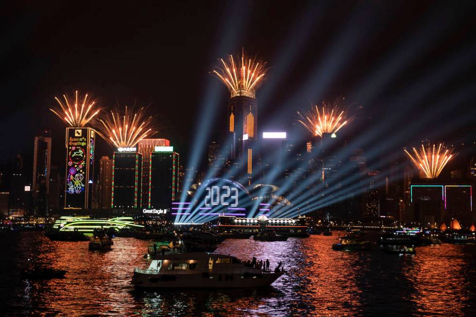 Fireworks are seen over Victoria Harbour at midnight on New Years Sunday Jan. 1, 2023 in Hong K ...
