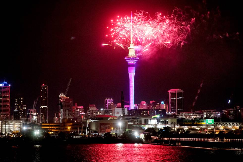 Fireworks explode over Sky Tower in central Auckland as New Year celebrations begin in New Zeal ...