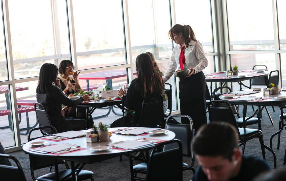 Southeast Career Technical Academy culinary student Isabella Stover serves diners at the studen ...