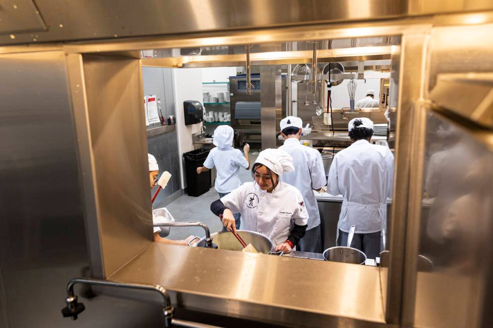 Southeast Career Technical Academy culinary students, including Ivette Huerta, center, work in ...