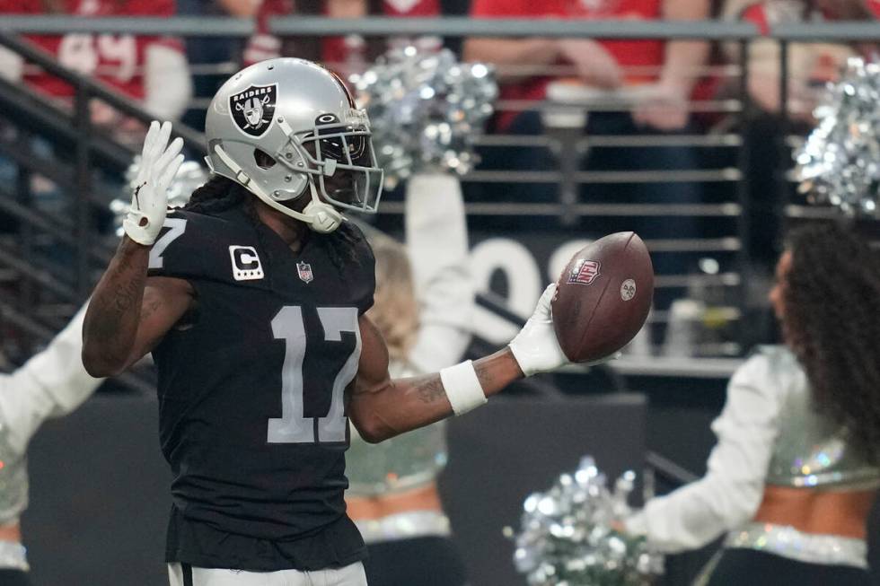 Las Vegas Raiders wide receiver Davante Adams (17) reacts after scoring a 60-yard touchdown dur ...