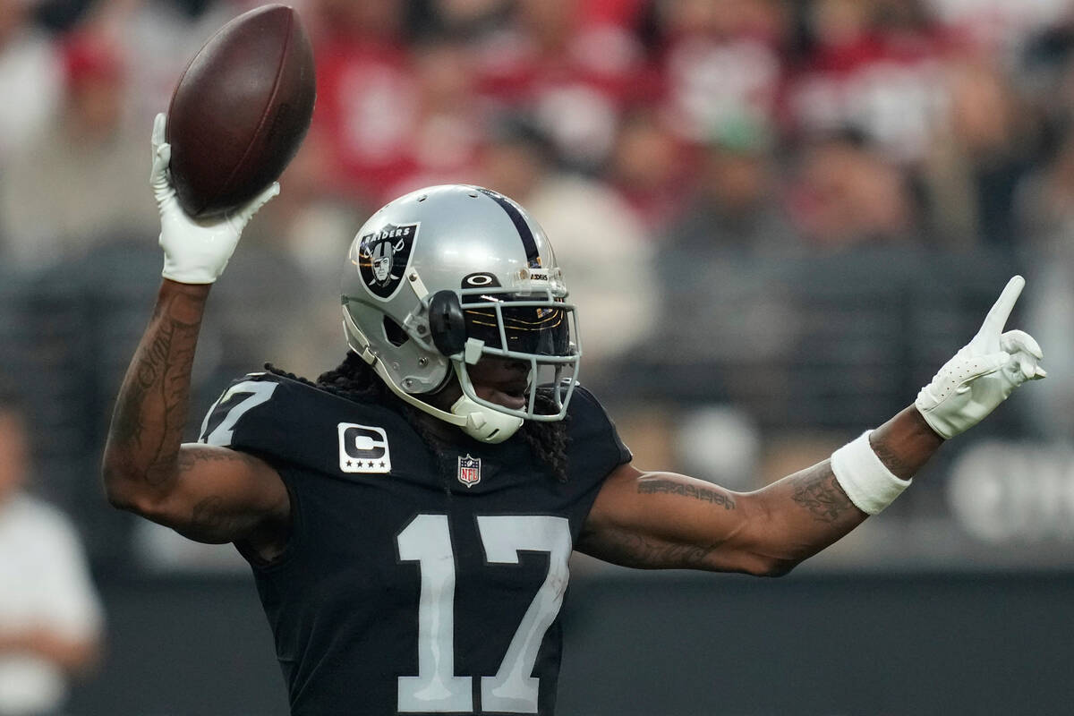 Las Vegas Raiders wide receiver Davante Adams (17) reacts after scoring a 60-yard touchdown dur ...