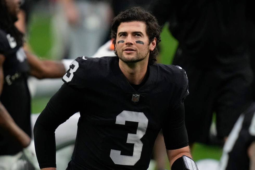 Las Vegas Raiders quarterback Jarrett Stidham stretches before an NFL football game between the ...