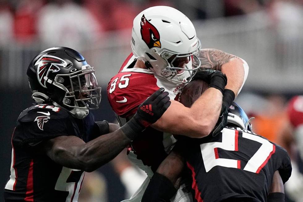 Arizona Cardinals tight end Trey McBride (85) is hit by Atlanta Falcons safety Richie Grant (27 ...