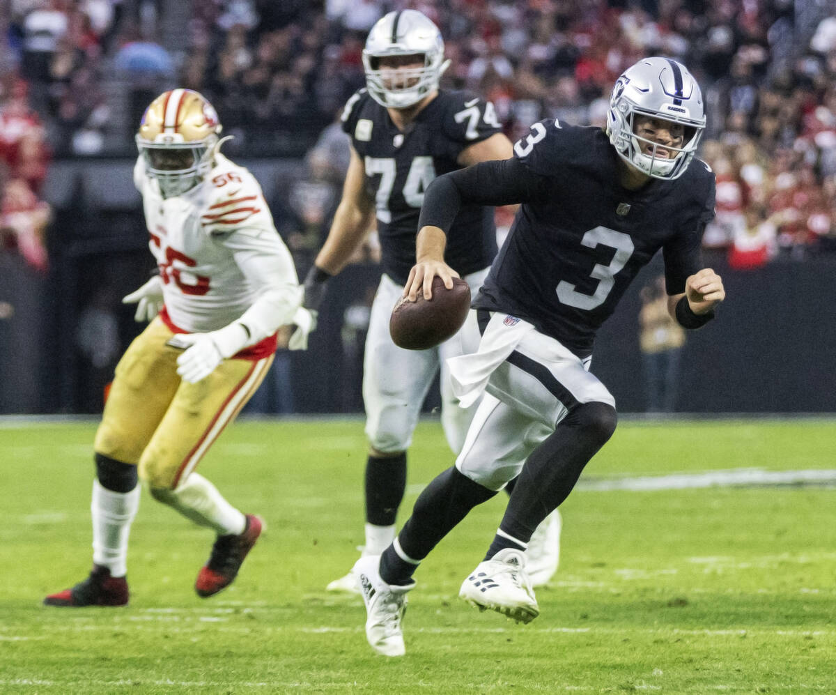 Raiders quarterback Jarrett Stidham (3) rushes with the football as offensive linemen Kolton Mi ...