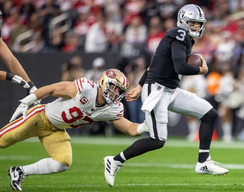 Raiders quarterback Jarrett Stidham (3) scrambles as San Francisco 49ers defensive end Nick Bos ...