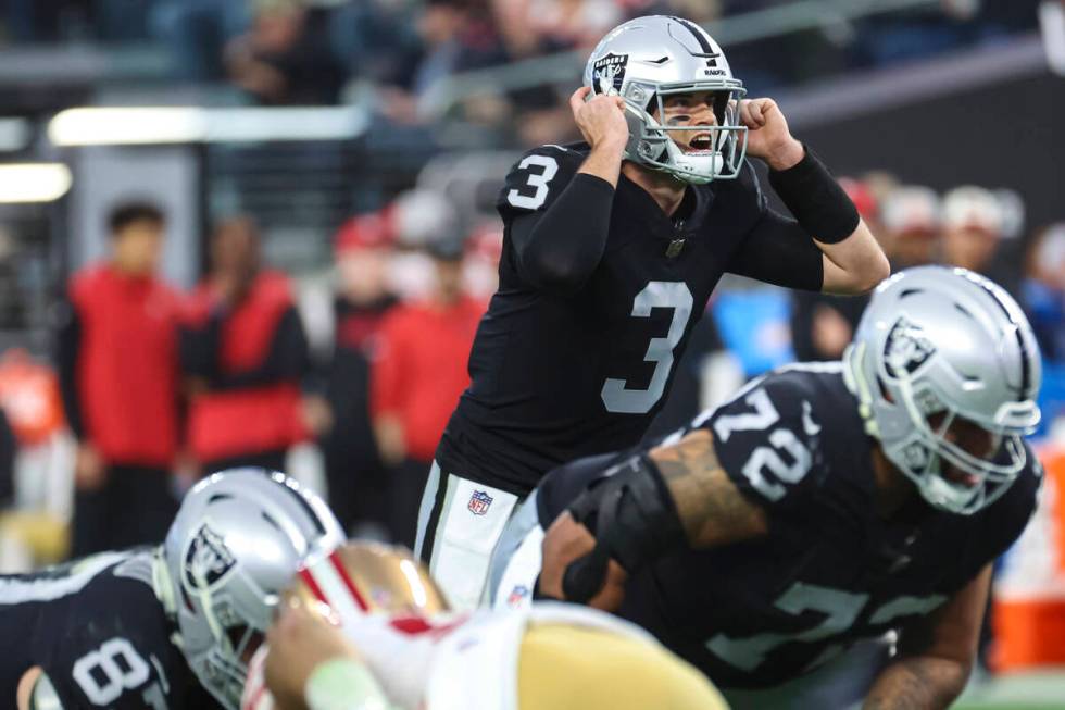 Raiders quarterback Jarrett Stidham (3) motions to teammates during the first half of an NFL ga ...