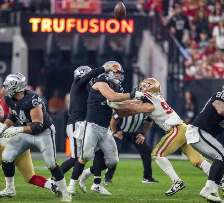 Raiders quarterback Jarrett Stidham (3) runs into offensive tackle Kolton Miller (74) as he tri ...