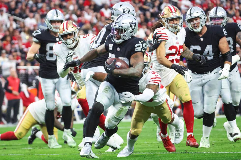 Raiders running back Josh Jacobs (28) runs the ball against the San Francisco 49ers during the ...