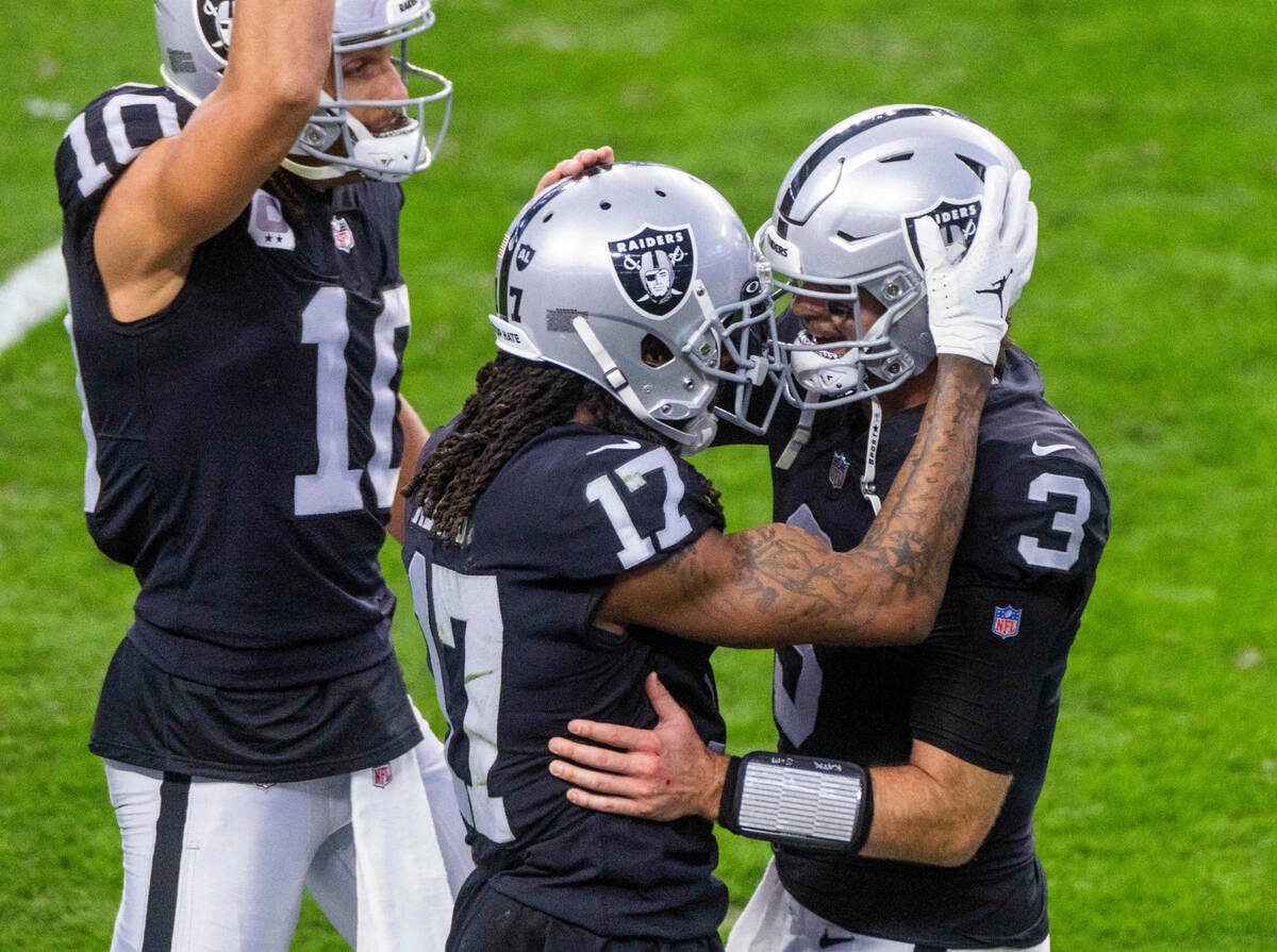 Raiders quarterback Jarrett Stidham (3) celebrates a touchdown with teammate wide receiver Dava ...