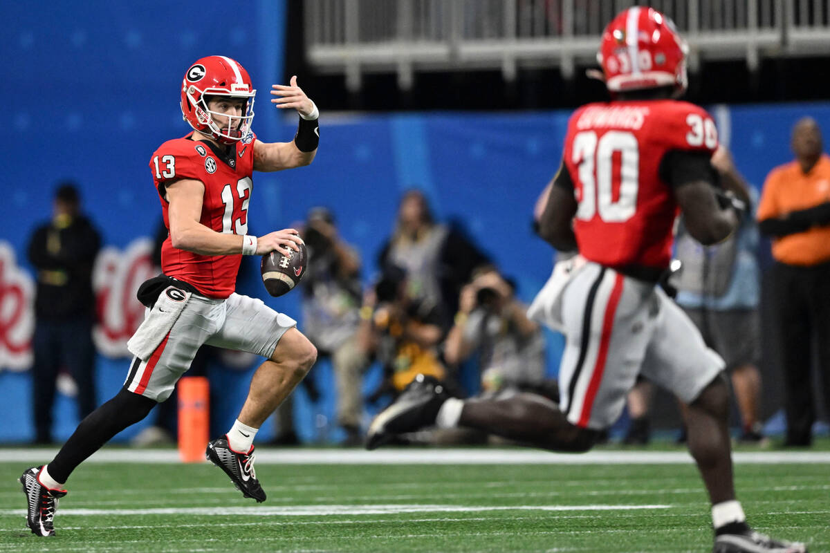 Georgia quarterback Stetson Bennett (13) runs against Ohio State during the first half of the P ...