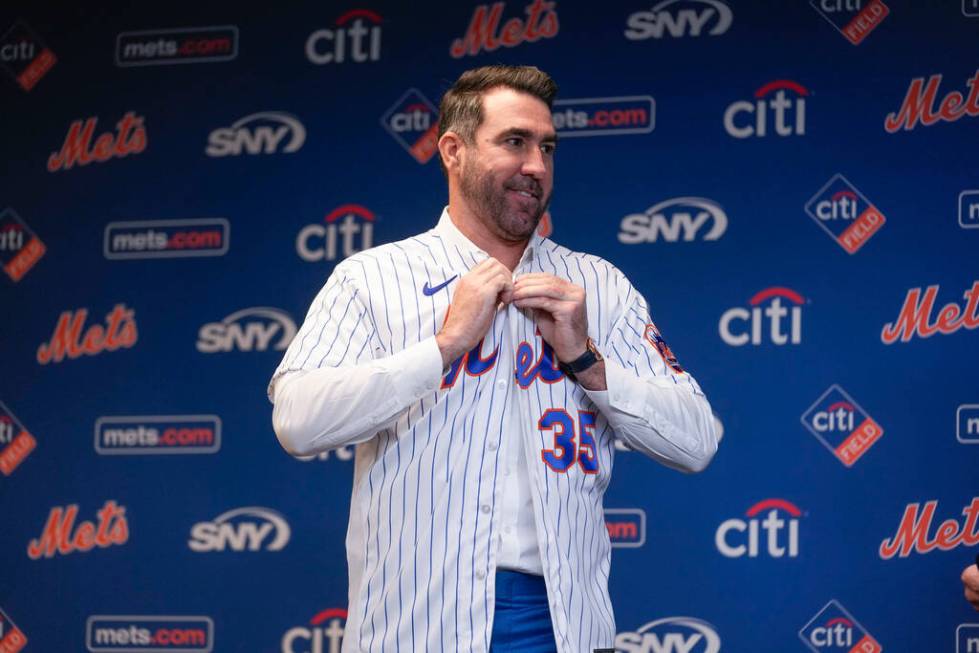 New York Mets pitcher Justin Verlander puts on his new jersey during a news conference at Citi ...